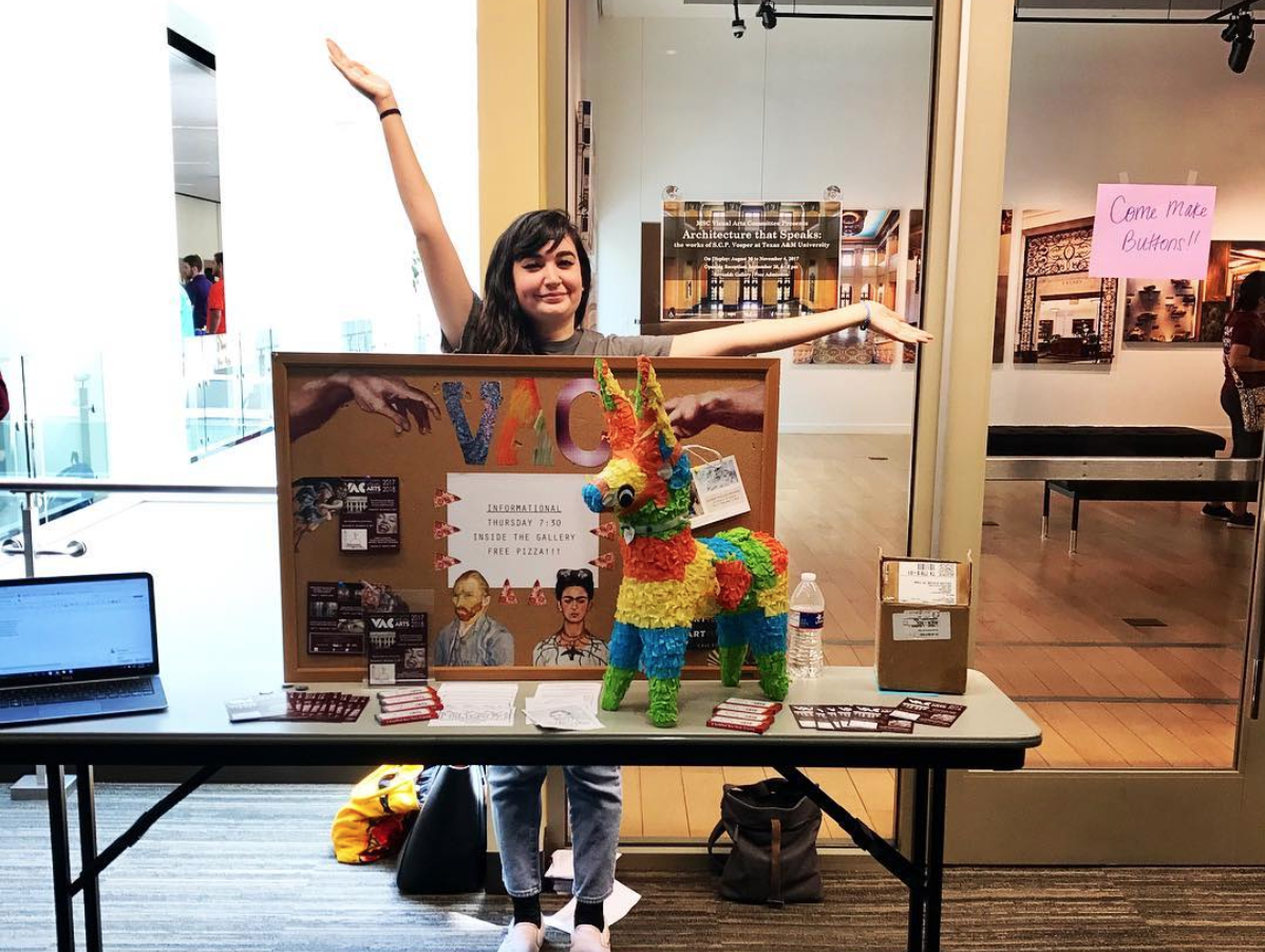 Photo of former MSC Visual Arts Committee student outside the gallery during an MSC Open House recruitment event.